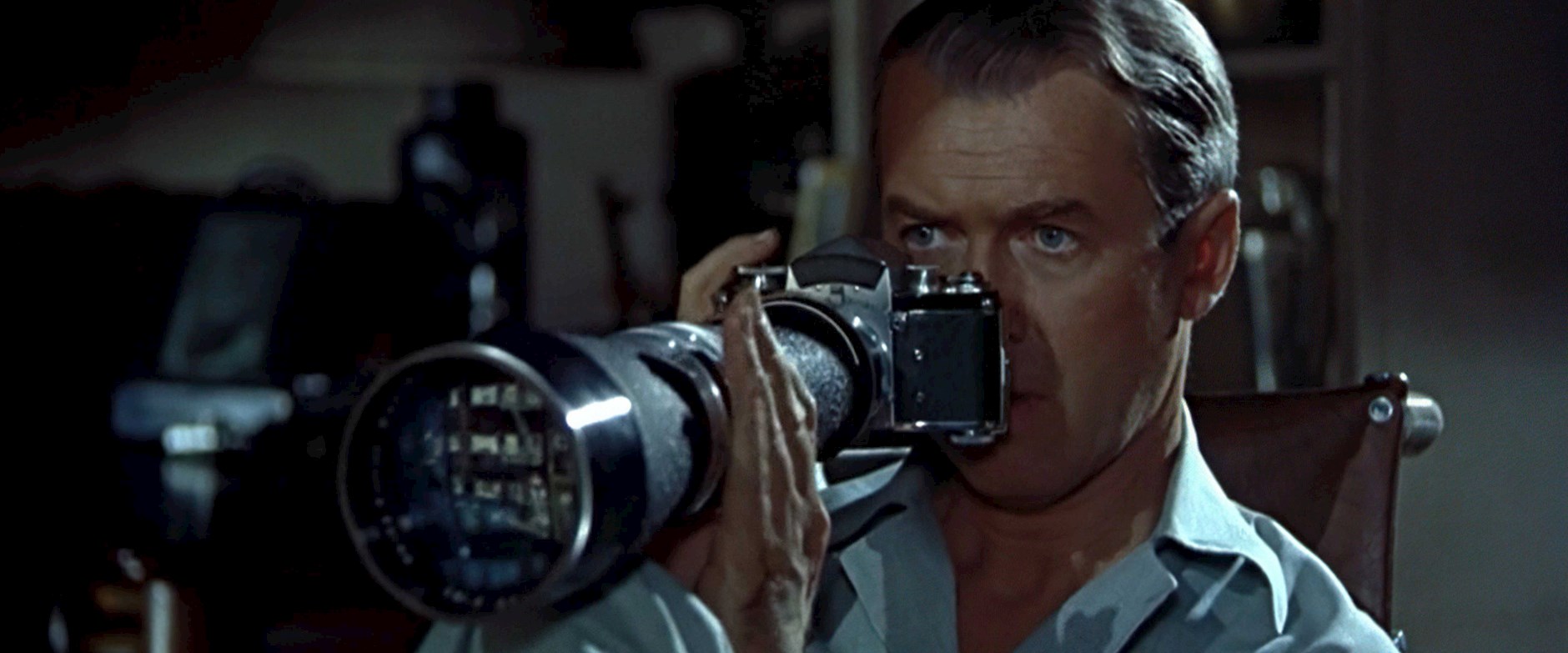 James Stewart holding a long lens camera in "Rear Window"