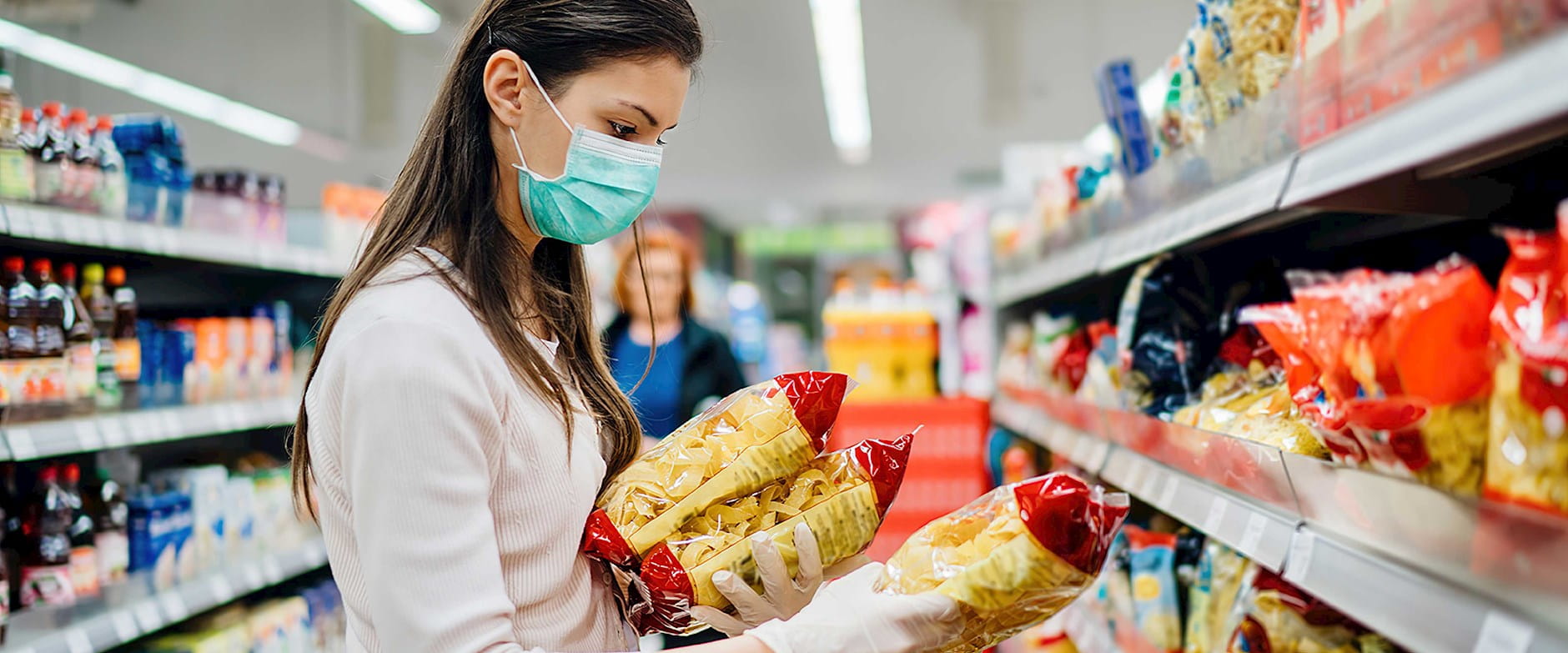Woman wearing a mask shopping at a grocery store
